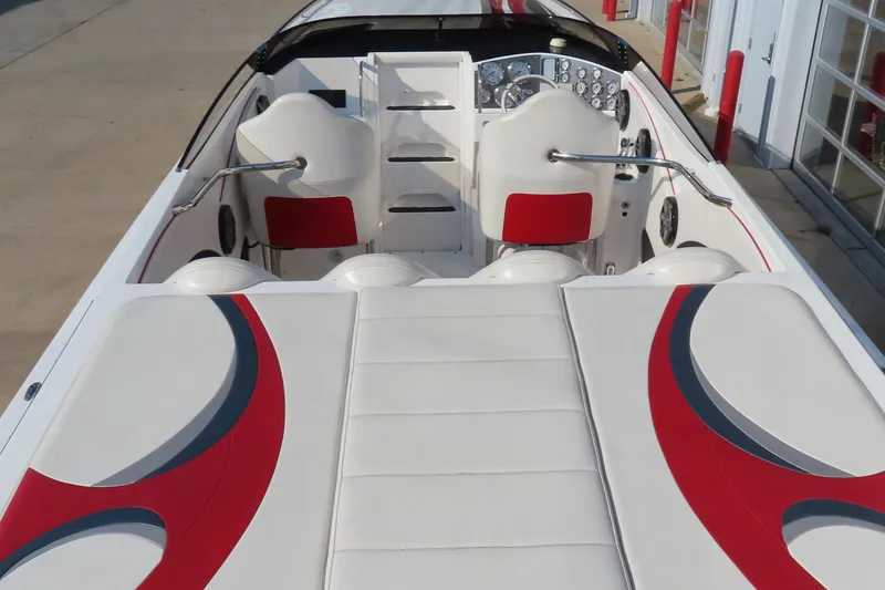 Slide: The Image of 2013 Nordic 39 Poker Run boat interior with white and red seating and dashboard. - 17