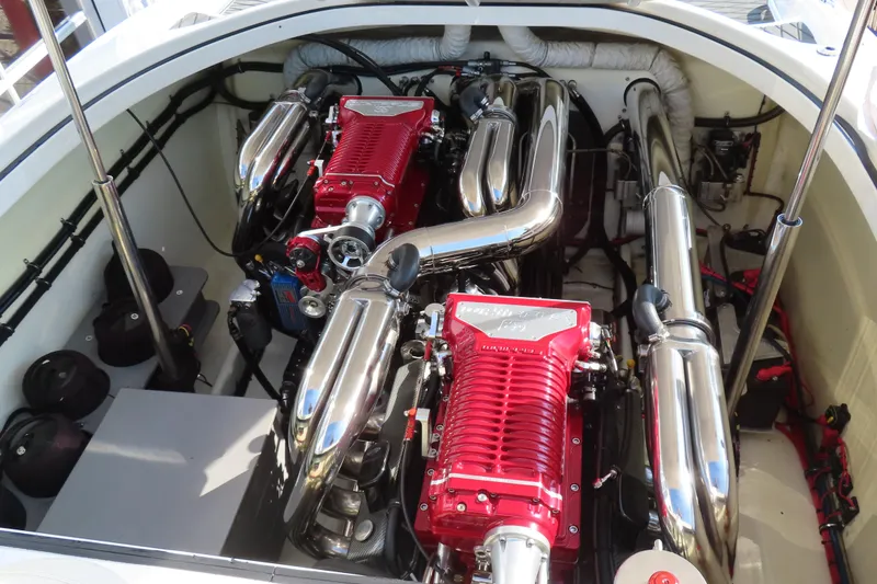 Slide: The Image of Engine compartment of a 2013 Nordic 39 POKER RUN boat with dual red engines. - 14