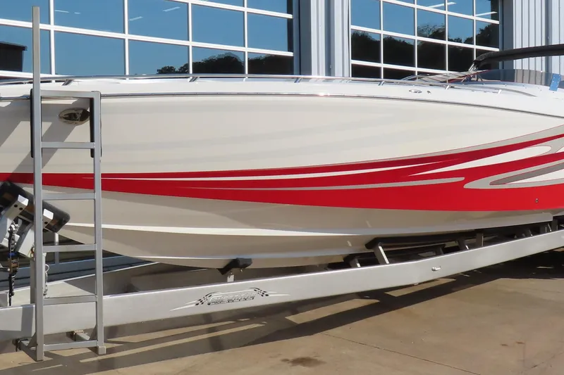 Slide: The Image of 2013 Nordic 39 POKER RUN boat with red and white design on a trailer. - 4
