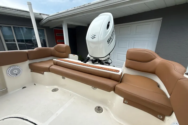 Slide: The Image of 2023 Pioneer 202 Islander boat with brown seating and Suzuki outboard motor. - 9