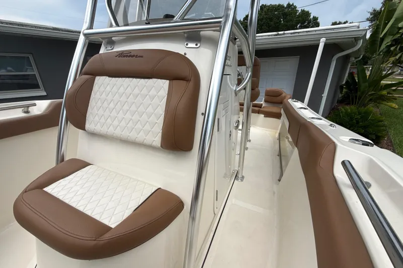 Slide: The Image of 2023 Pioneer 202 Islander boat interior with brown and white cushioned seating. - 15