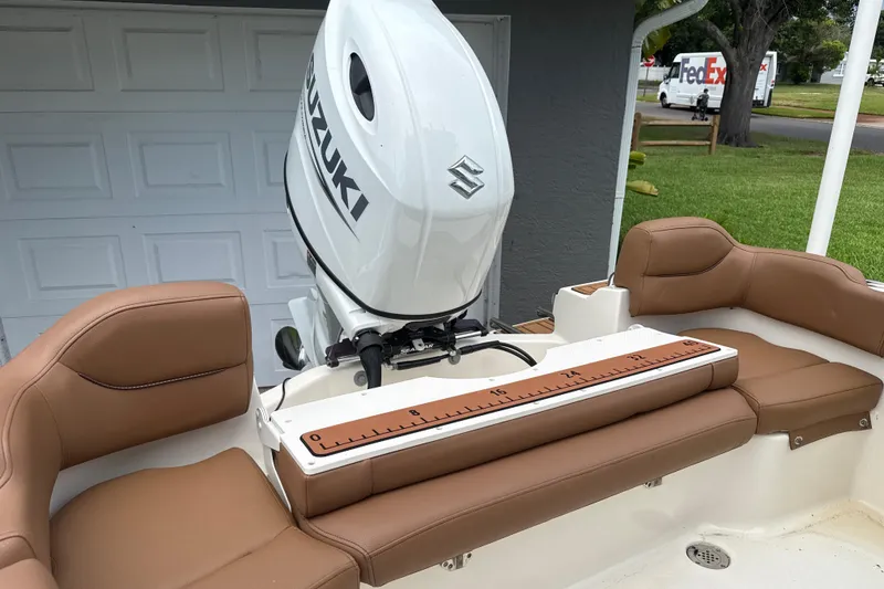 Slide: The Image of 2023 Pioneer 202 Islander boat with Suzuki outboard motor and tan seating. - 10