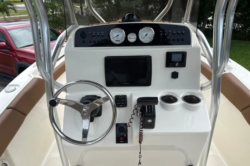 Slide: The Image of 2023 Pioneer 202 Islander boat dashboard with steering wheel, gauges, and navigation controls. - 5