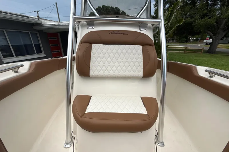 Slide: The Image of 2023 Pioneer 202 Islander boat seat with brown and white diamond-pattern upholstery. - 14