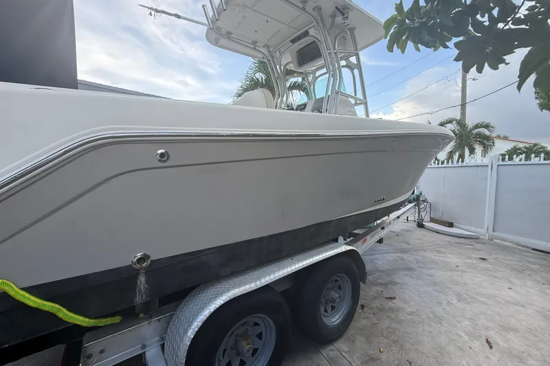 Slide: The Image of 2007 Robalo R260 Center Console boat on trailer, parked outdoors. - 26