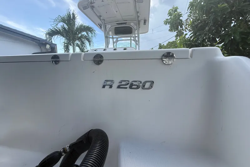 Slide: The Image of 2007 Robalo R260 Center Console boat with visible model emblem and tropical background. - 24