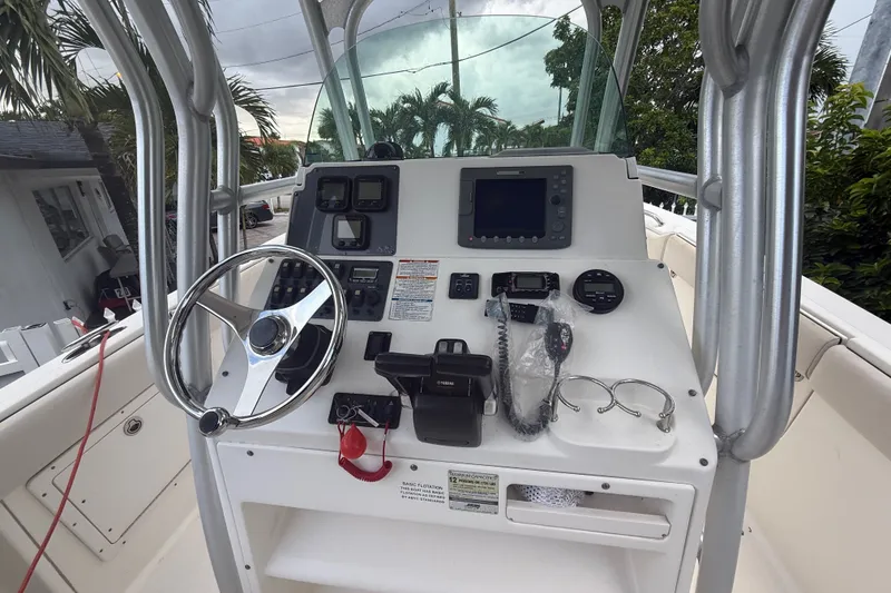 Slide: The Image of 2007 Robalo R260 Center Console boat dashboard with steering wheel and navigation equipment. - 53