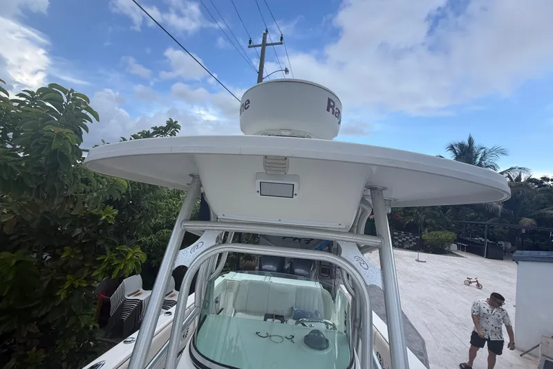 Slide: The Image of 2007 Robalo R260 Center Console boat with radar, surrounded by tropical greenery. - 33