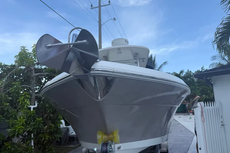 Slide: The Image of 2007 Robalo R260 Center Console boat with anchor, parked outdoors under blue sky. - 2