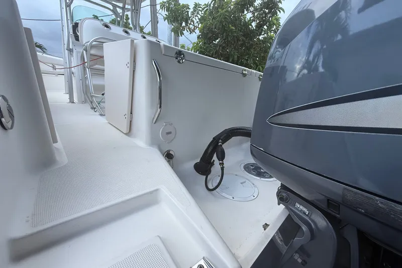 Slide: The Image of 2007 Robalo R260 Center Console boat interior with engine and seating area. - 11