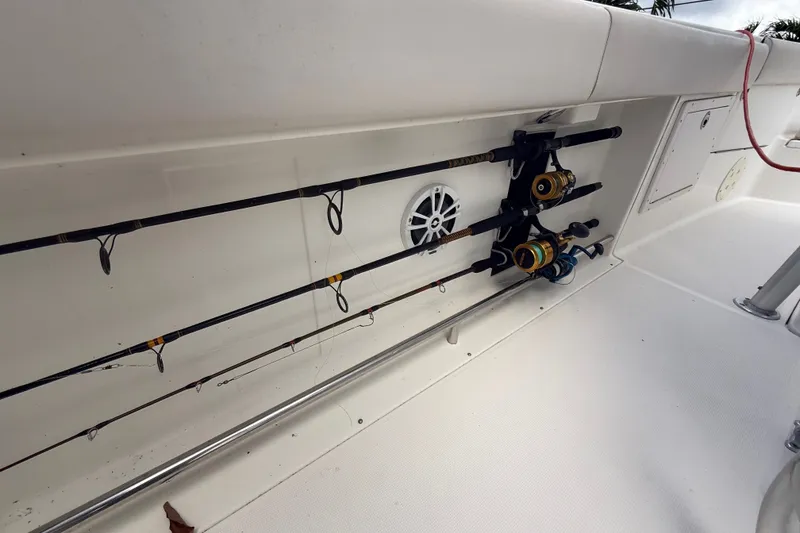 Slide: The Image of Fishing rods stored on a 2007 Robalo R260 Center Console boat deck. - 60