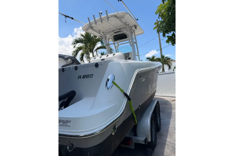 Slide: The Image of 2007 Robalo R260 Center Console boat on trailer, palm trees in background. - 4
