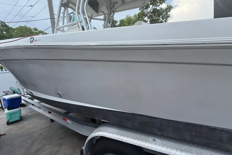 Slide: The Image of 2007 Robalo R260 Center Console boat on trailer, side view, outdoors. - 4