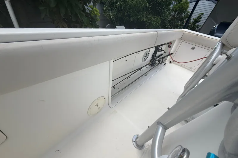 Slide: The Image of 2007 Robalo R260 Center Console boat interior with fishing rod storage and seating. - 48