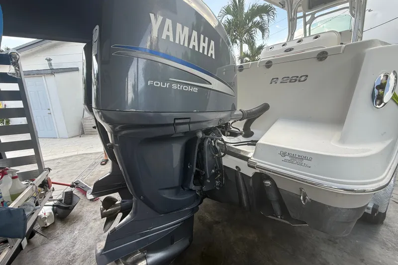 Slide: The Image of 2007 Robalo R260 Center Console with Yamaha four-stroke engine, parked outdoors. - 14