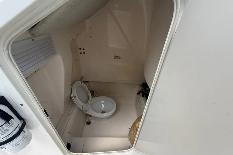 Slide: The Image of 2007 Robalo R260 Center Console boat interior with compact marine toilet. - 46