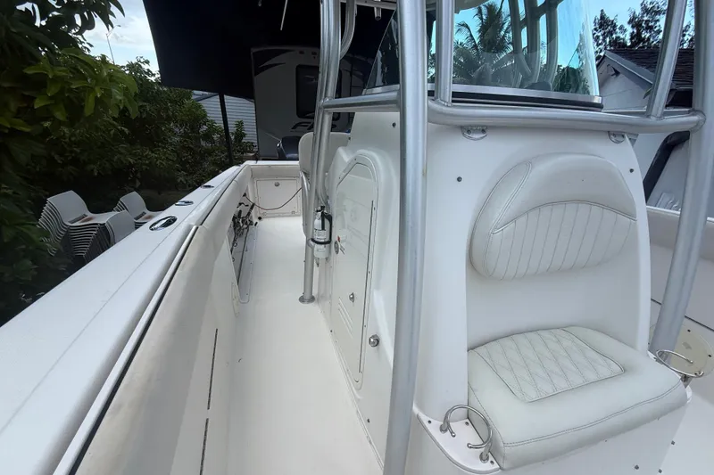 Slide: The Image of 2007 Robalo R260 Center Console boat interior with white seating and storage compartments. - 42