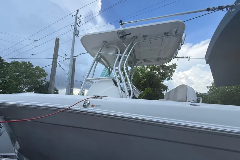 Slide: The Image of 2007 Robalo R260 Center Console boat with T-top against a cloudy sky backdrop. - 6