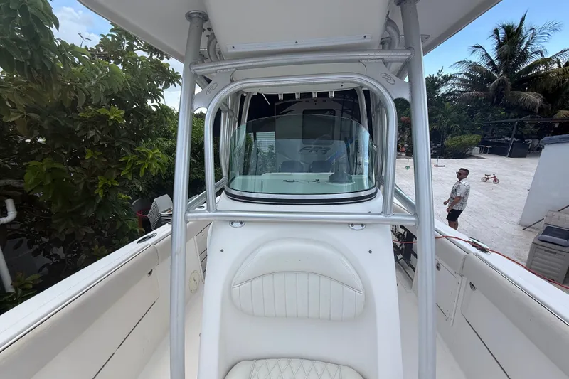 Slide: The Image of 2007 Robalo R260 Center Console boat with white seating and sturdy frame, docked outdoors. - 31