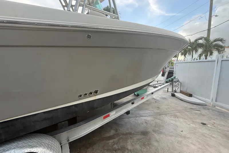 Slide: The Image of 2007 Robalo R260 Center Console boat on trailer, side view, outdoors. - 27