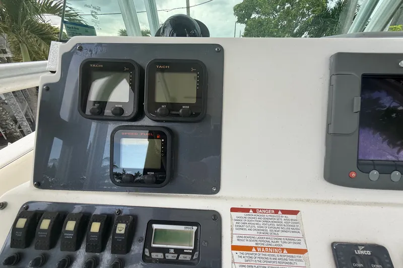 Slide: The Image of 2007 Robalo R260 Center Console dashboard with tachometers and speed fuel gauges. - 50