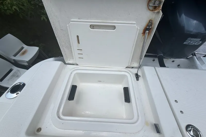 Slide: The Image of Open storage compartment on a 2007 Robalo R260 Center Console boat. - 59
