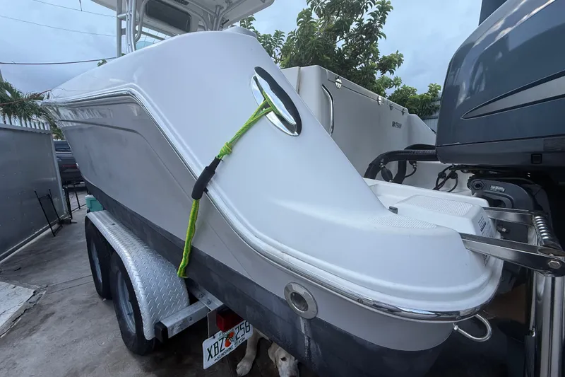 Slide: The Image of 2007 Robalo R260 Center Console boat on trailer, secured with green rope. - 9