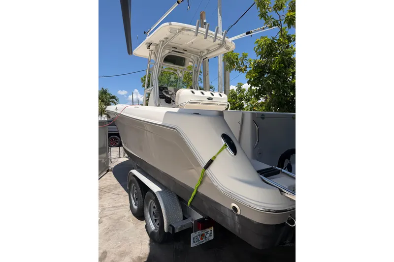 Slide: The Image of 2007 Robalo R260 Center Console boat on trailer, parked outdoors. - 13