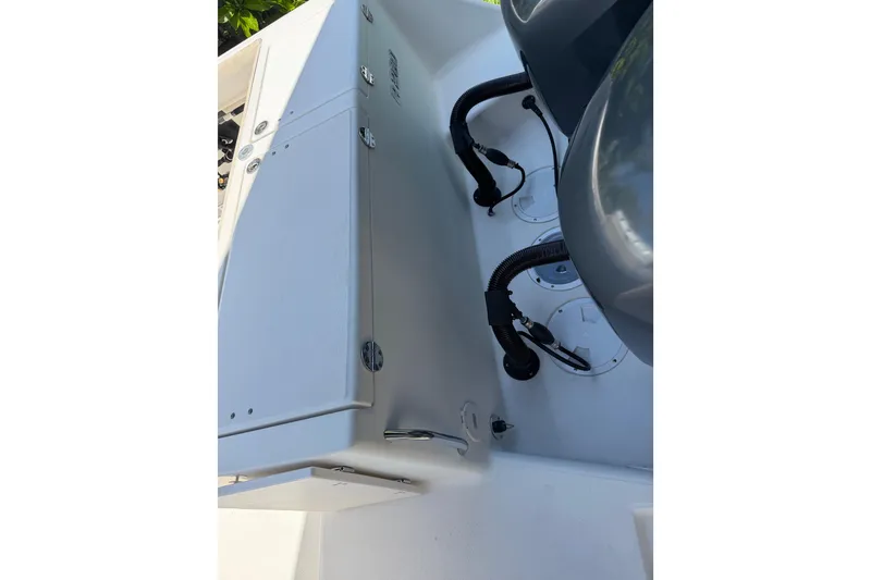 Slide: The Image of 2007 Robalo R260 Center Console boat interior with storage compartments and engine cables. - 15