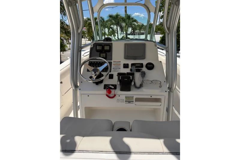 Slide: The Image of 2007 Robalo R260 Center Console boat dashboard with steering wheel and navigation controls. - 11