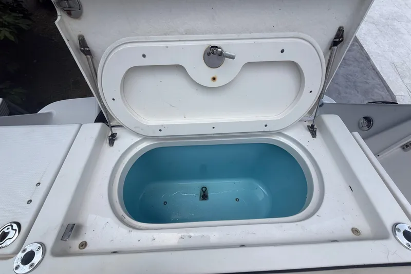 Slide: The Image of Livewell compartment on a 2007 Robalo R260 Center Console boat, open and empty. - 58