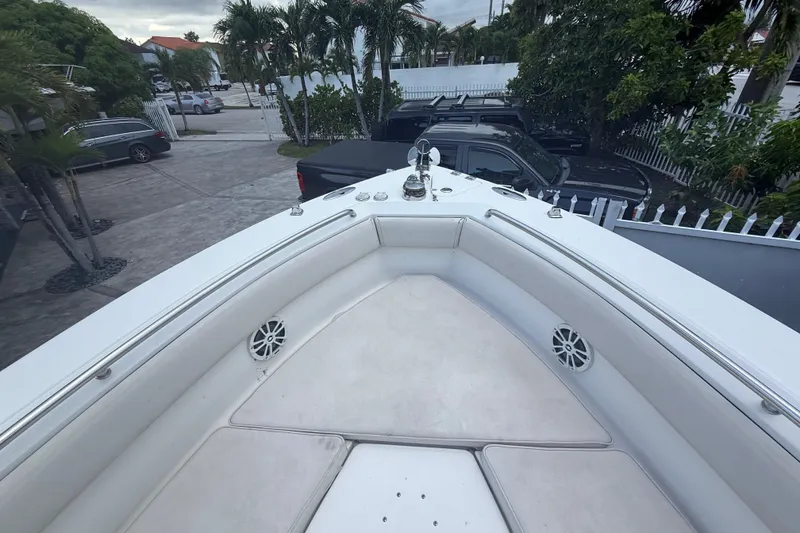 Slide: The Image of 2007 Robalo R260 Center Console boat bow with seating and speakers, parked near palm trees. - 37