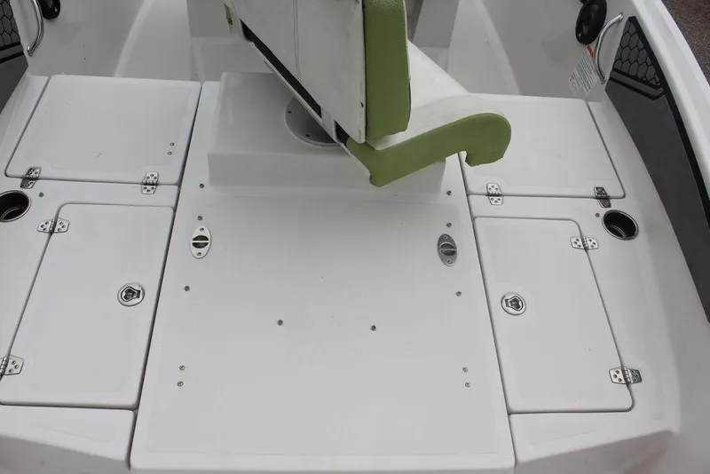 Slide: The Image of Interior of a 2017 Scarab 195 boat featuring white storage compartments and a green seat. - 10
