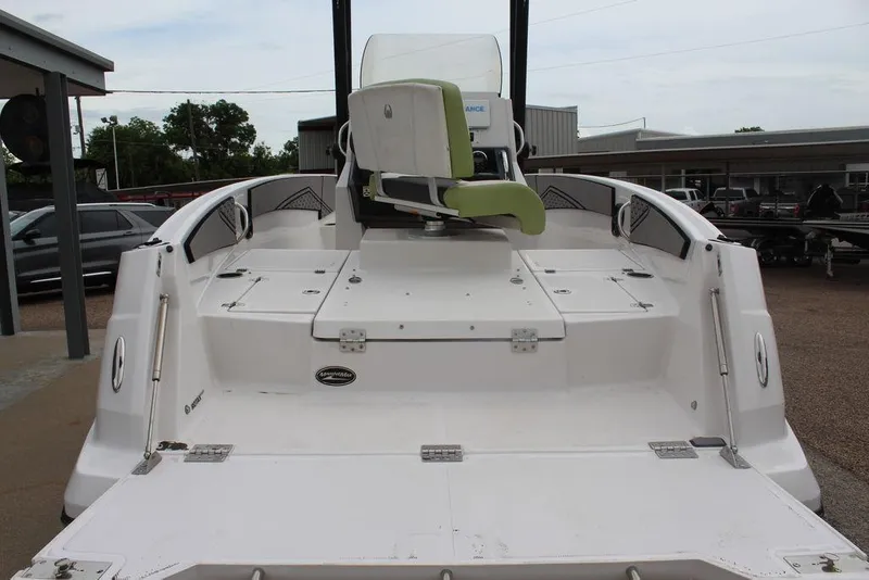 Slide: The Image of 2017 Scarab 195 boat with white deck and green seat, parked outdoors. - 7