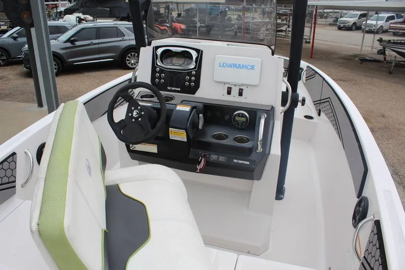 Slide: The Image of Interior view of a 2017 Scarab 195 boat with steering console and seating. - 9