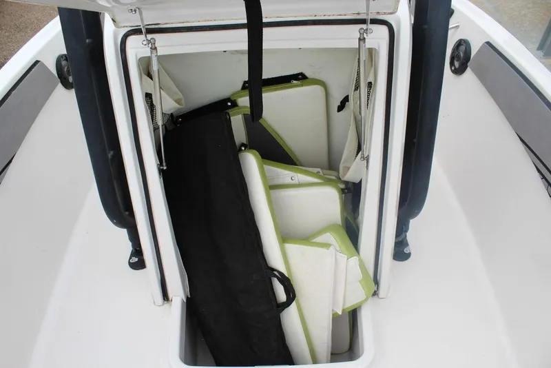 Slide: The Image of Open storage compartment on 2017 Scarab 195 boat with cushions and accessories. - 11