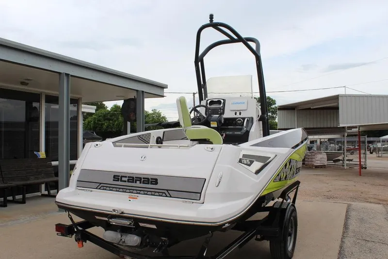 Slide: The Image of 2017 Scarab 195 boat on trailer, parked outdoors near buildings. - 4