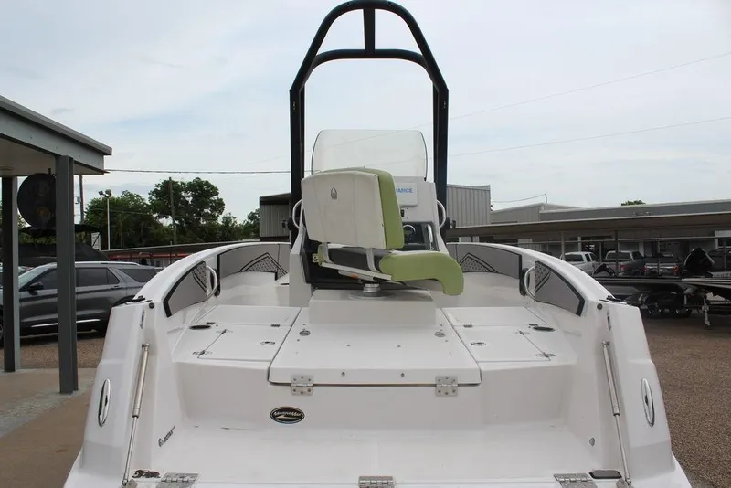 Slide: The Image of 2017 Scarab 195 boat with green seating, viewed from the rear in a parking area. - 14