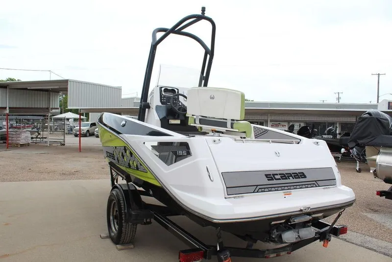 Slide: The Image of 2017 Scarab 195 boat on trailer, featuring sleek design and vibrant graphics. - 5