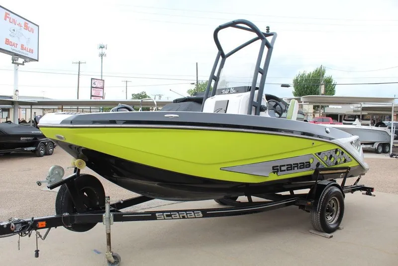 Slide: The Image of 2017 Scarab 195 boat in vibrant yellow on a trailer at a dealership. - 8
