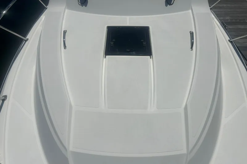 Slide: The Image of 2021 Pursuit OS 325 Offshore boat deck with hatch and stainless steel handles. - 6