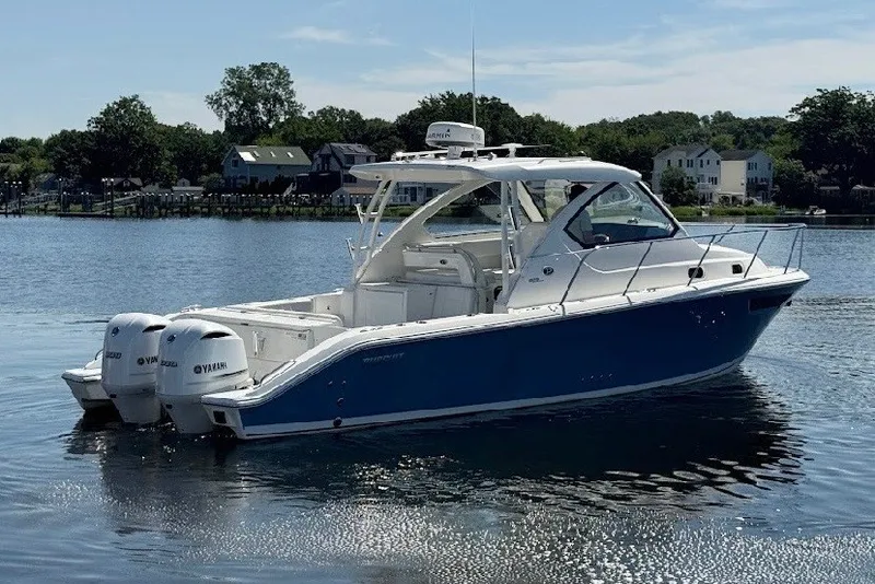 Slide: The Image of 2021 Pursuit OS 325 Offshore boat on calm water, featuring twin Yamaha engines. - 1
