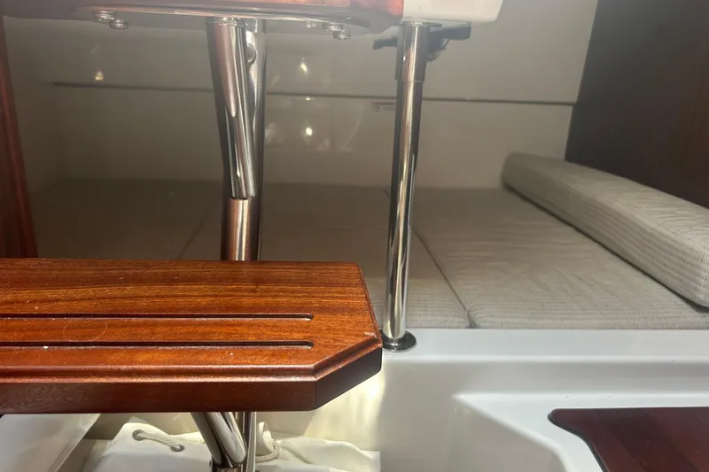 Slide: The Image of Interior cabin view of 2021 Pursuit OS 325 Offshore boat with wooden and metal finishes. - 17
