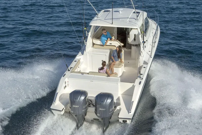 Slide: The Image of Manufacturer Provided Image: 2021 Pursuit OS 325 Offshore boat cruising on open water. - 5