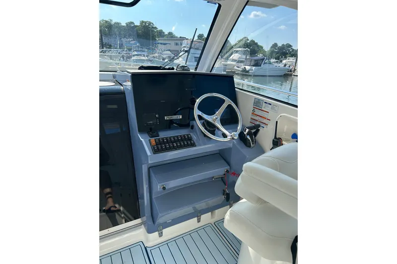 Slide: The Image of Helm of 2021 Pursuit OS 325 Offshore boat with steering wheel and controls. - 7