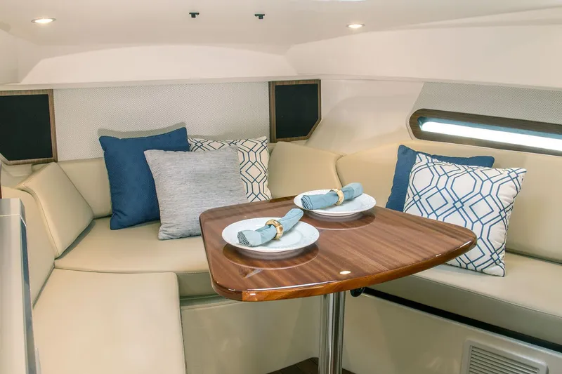 Slide: The Image of Manufacturer Provided Image: 2021 Pursuit OS 325 Offshore cabin with dining table and cushioned seating. - 16