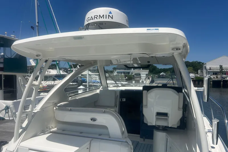 Slide: The Image of 2021 Pursuit OS 325 Offshore boat with Garmin radar, docked at a marina. - 18