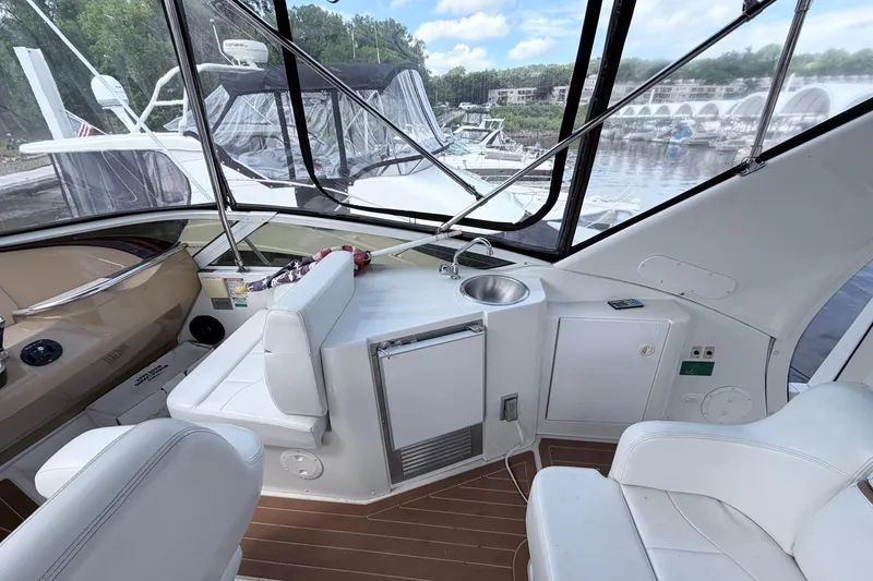 Slide: The Image of 2003 Carver 396 Motor Yacht interior with seating, sink, and marina view. - 11