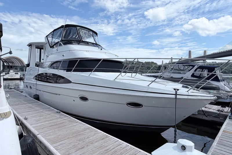 Slide: The Image of 2003 Carver 396 Motor Yacht docked at marina under blue sky. - 2