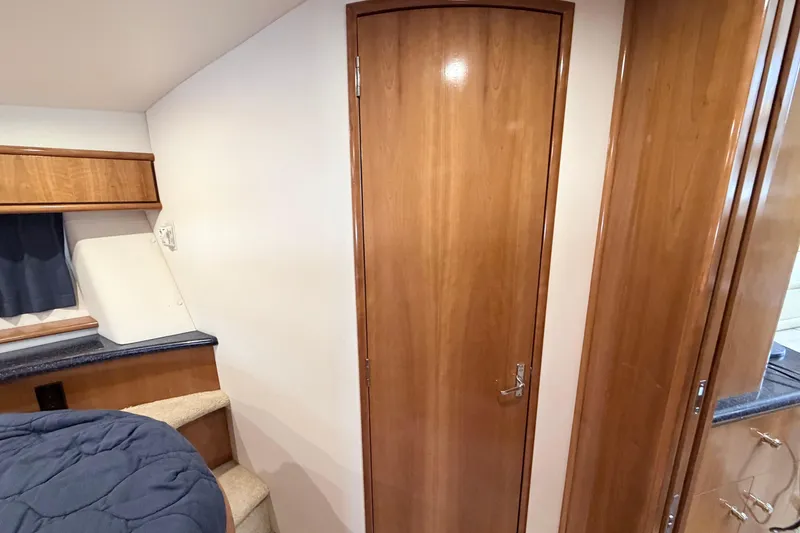 Slide: The Image of Interior of 2003 Carver 396 Motor Yacht with wooden door and cozy cabin space. - 26